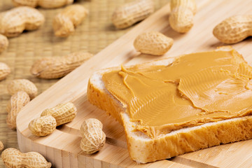 Delicious peanut butter sandwich on a wooden background