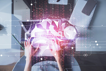 Double exposure of woman working on computer andhuman brain hologram drawing. Top View. Ai concept.