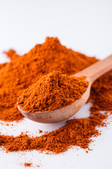 aromatic spicy chili powder on a white background