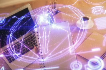 Double exposure of woman hands typing on computer and general theme hologram drawing. Education concept.