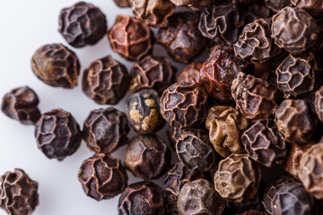 fragrant black pepper on white acrylic background