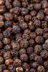 fragrant black pepper on white acrylic background