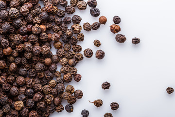 fragrant black pepper on white acrylic background
