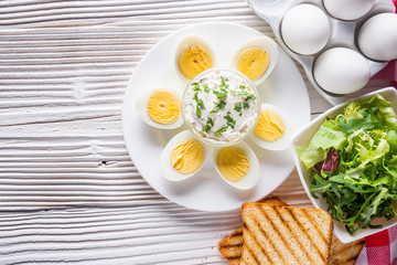 boiled chicken eggs on a white wooden rustic background