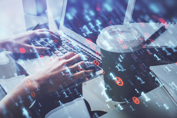 Double exposure of woman hands working on computer and data theme hologram drawing. Tech concept.