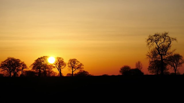 red sunset rural countryside landscape - 1 minute slow time lapse - england