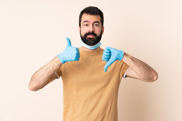 Caucasian man with beard protecting from the coronavirus with a mask and gloves over isolated...