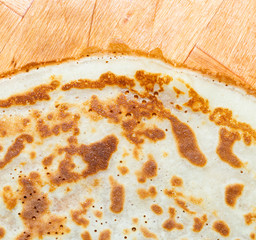 Fried pancakes. The texture of the dough. A treat on Shrove Tuesday. Culinary products on a bamboo tray.