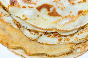 Fried pancakes. The texture of the dough. A treat on Shrove Tuesday. Culinary product.