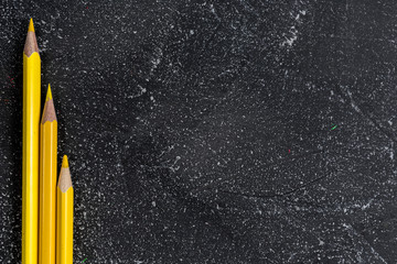 Yellow pencils on a black stone table