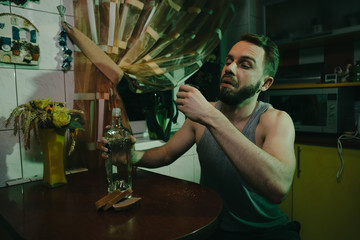 Drinking man with antiseptic and mask