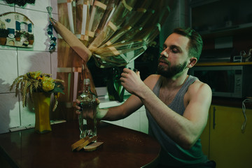 Drinking man with antiseptic and mask