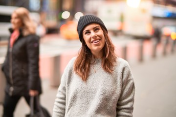 Young beautiful woman smiling happy and confident. Standing with smile on face walking at the city