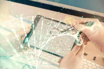 Double exposure of man's hands holding and using a phone and DNA drawing. Medical education concept.