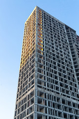 Fototapeta na wymiar high cement building building against the sky engineering design