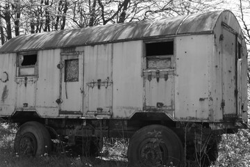 Old ruined wagon on rubber wheels, abandoned in natural surroundings