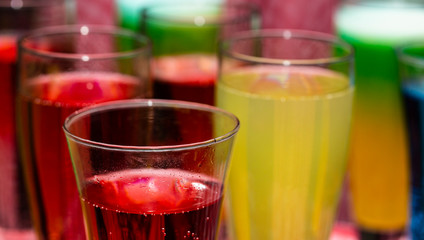 Glasses with a cocktail. Multicolored drinks. Drunk party.