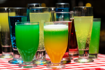 Glasses with a cocktail. Multicolored drinks. Drunk party.