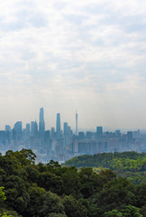 Fototapeta na wymiar Taking photos of Guangzhou downtown at the top of Baiyun Mountain