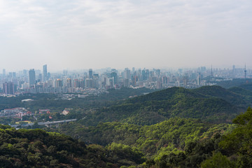 Taking photos of Guangzhou downtown at the top of Baiyun Mountain