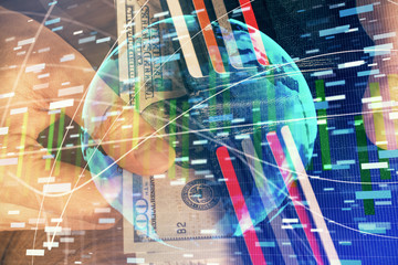 Multi exposure of financial theme drawing hologram and USA dollars bills and man hands. Business...