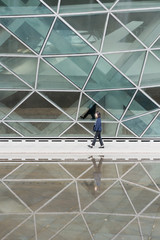 Young business women passing through glass buildings