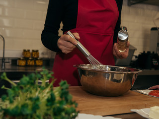 The process of making pancakes. Cook in the kitchen makes the dough