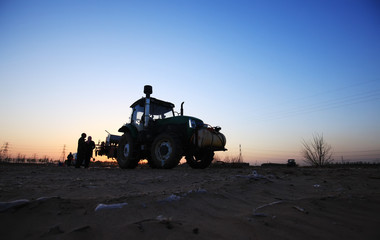 Fototapeta premium The tractor in farmland farming