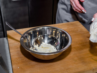 The process of making pancakes. Cook in the kitchen makes the dough