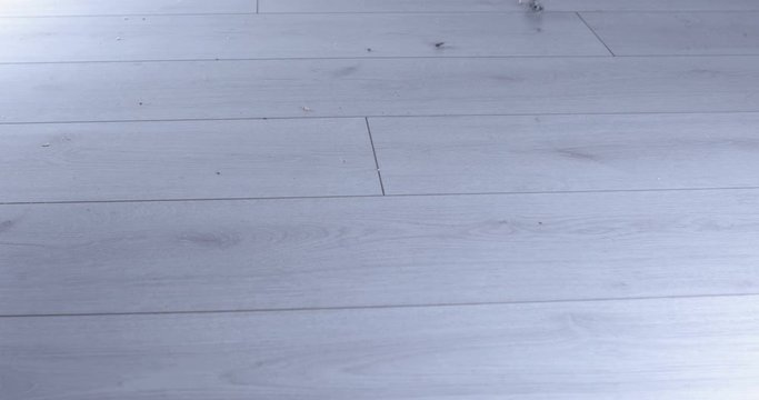 Vacuum cleaner rolling from side to side on a parquet floor	