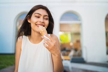 Woman enjoying and eating an ice cream.