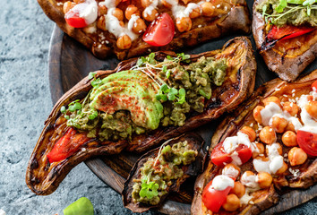 Baked sweet potato toast with roasted chickpeas, tomatoes, goat cheese, sauce guacamole, avocado,...