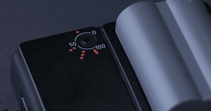 Hands attach battery to charger