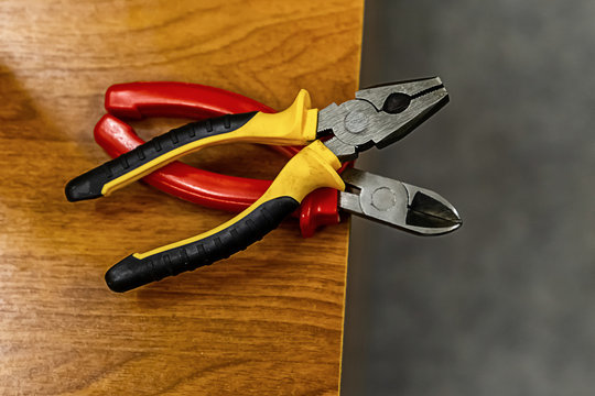 pair of pliers bright handles plastic yellow red working hand tools