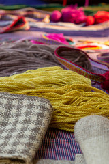 Fototapeta na wymiar vertical photo yellow yarn set material handicraft hobby close up on fabric background