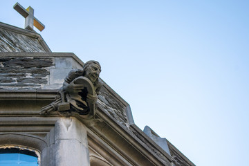 Looking Up at a Strange Statue of a Face Against a Clear Sky