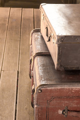 Fototapeta na wymiar old vintage brown leather suitcase closeup vertical photo travel design