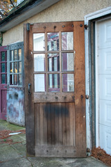 An Old Brown Wooden Door With Windows Attached to a Garage