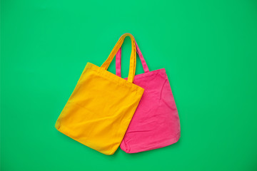 Canvas bag or cloth bag made from natural materials with green background. Ideas for reducing plastic bags.