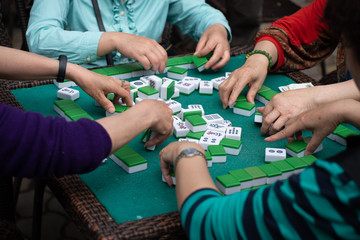people playing mahjong in a tea garden in china