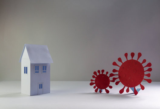 Representation Of Coronavirus COVID 19 Made From Paper Trying To Enter Quarantined Houses