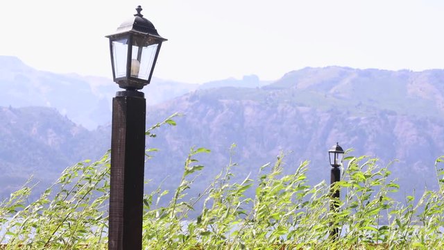 Street lamps with mountain background in a windy day