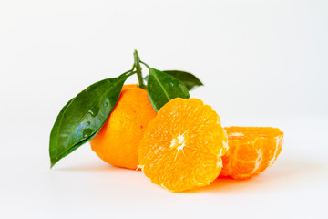 Tangerine Orange or clementine with green leaf with sliced orange white background