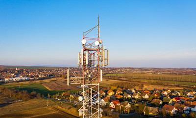 Elevated view of a telecommunication and mobile phone cell tower standing out on the confines of the city