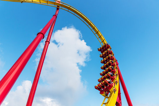 Rollercoaster Ride in theme park with blue sky