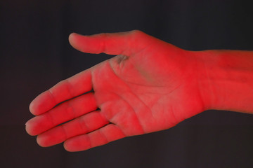 Close-up shot. Man hand with red light. Stop Coronavirus concept.
