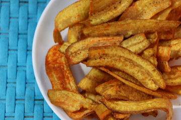 Banana chips in a white plate, salty and spicy, Indian snack