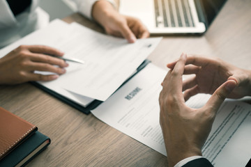 Female employee are describing the employment history of the employer about his work experience.