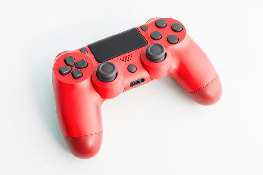 A joystick controller on isolated background, red colored