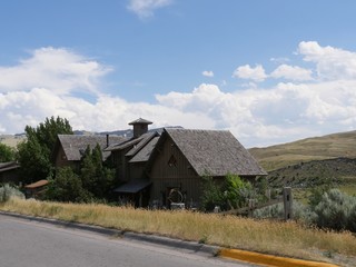 Wooden cabins along the road by the banks of Yellowstone River in Gardiner, Montana.